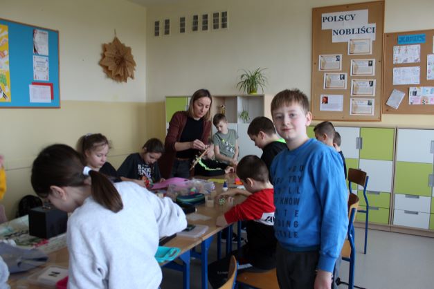 Na zdjęciu znajdują się uczniowie z klasy 4d wykonujący pomoce dydaktyczno -
sensoryczne. Uczniowie wykonują pomoce przy stole.
