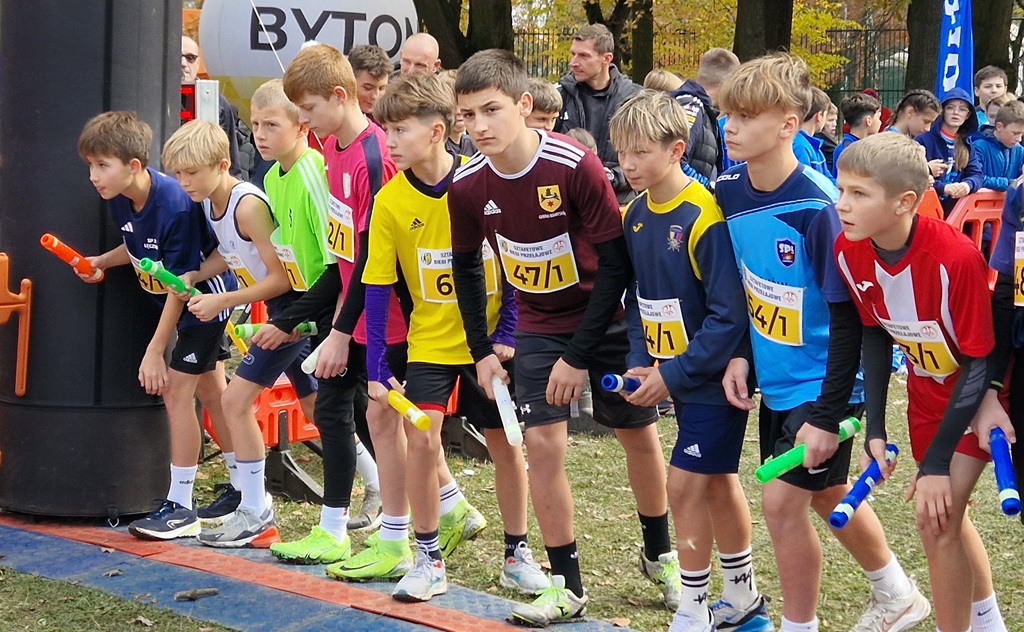 uczeń naszej szkoły stoi na starcie przygotowany do biegu, w ręce trzyma pałeczkę sztafetową