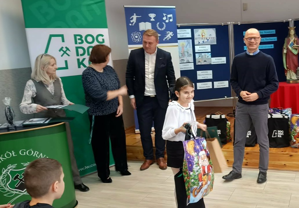 Zwyciężczyni pieszego miejsca trzyma torbę z nagrodami i dyplom.