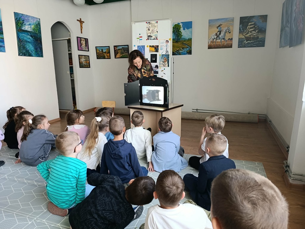 Dzieci oglądają teatrzyk cieni