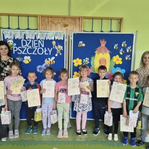dzieci trzymają w rękach dyplomy i upominki