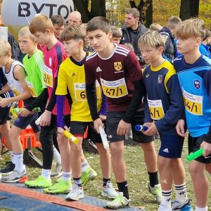 uczeń naszej szkoły stoi na starcie przygotowany do biegu, w ręce trzyma pałeczkę sztafetową